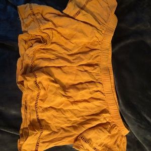 Yellow off the shoulder ruffled crop top.